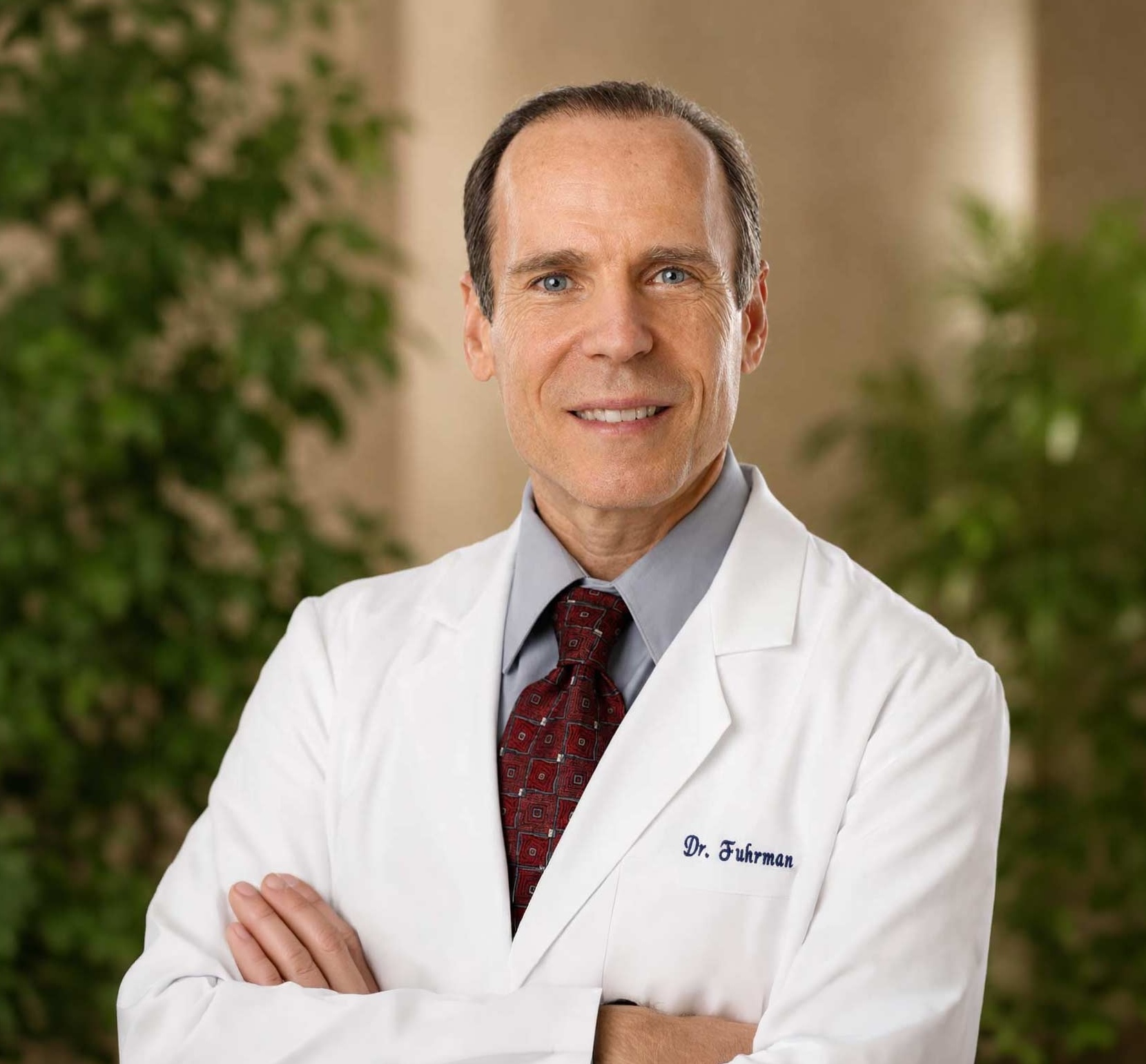 Portrait of Dr. Joel Fuhrman, M.D., in a white physician’s coat