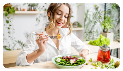 picture of woman eating salad